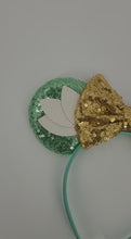 Load and play video in Gallery viewer, Green Lily Pad Themed Ear Headband with Gold Sequined Bow
